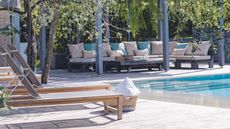 Examples of the best wooden outdoor furniture, wooden sun loungers opposite a wooden outdoor sectional