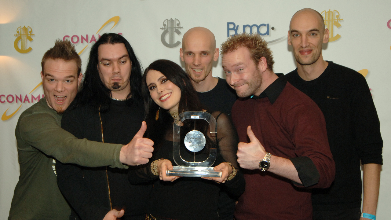 Within Temptation looking happy and holding an award