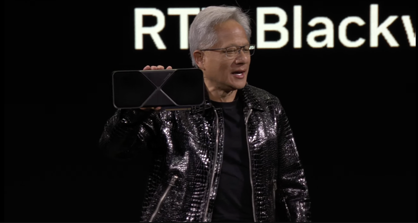 Nvidia CEO Jensen Huang holding the RTX 5090 at CES 2025