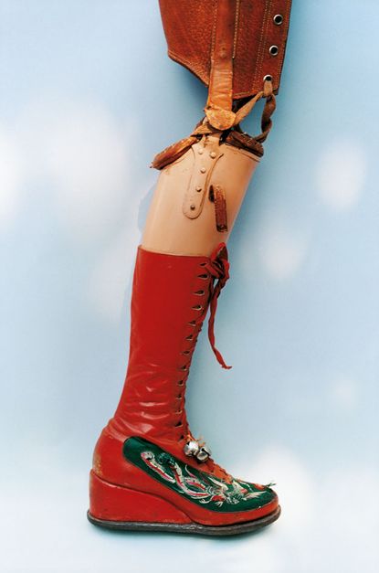 Rear view of two pink boot shows with slightly worn sole. The boots have a decorative attachment around them. 