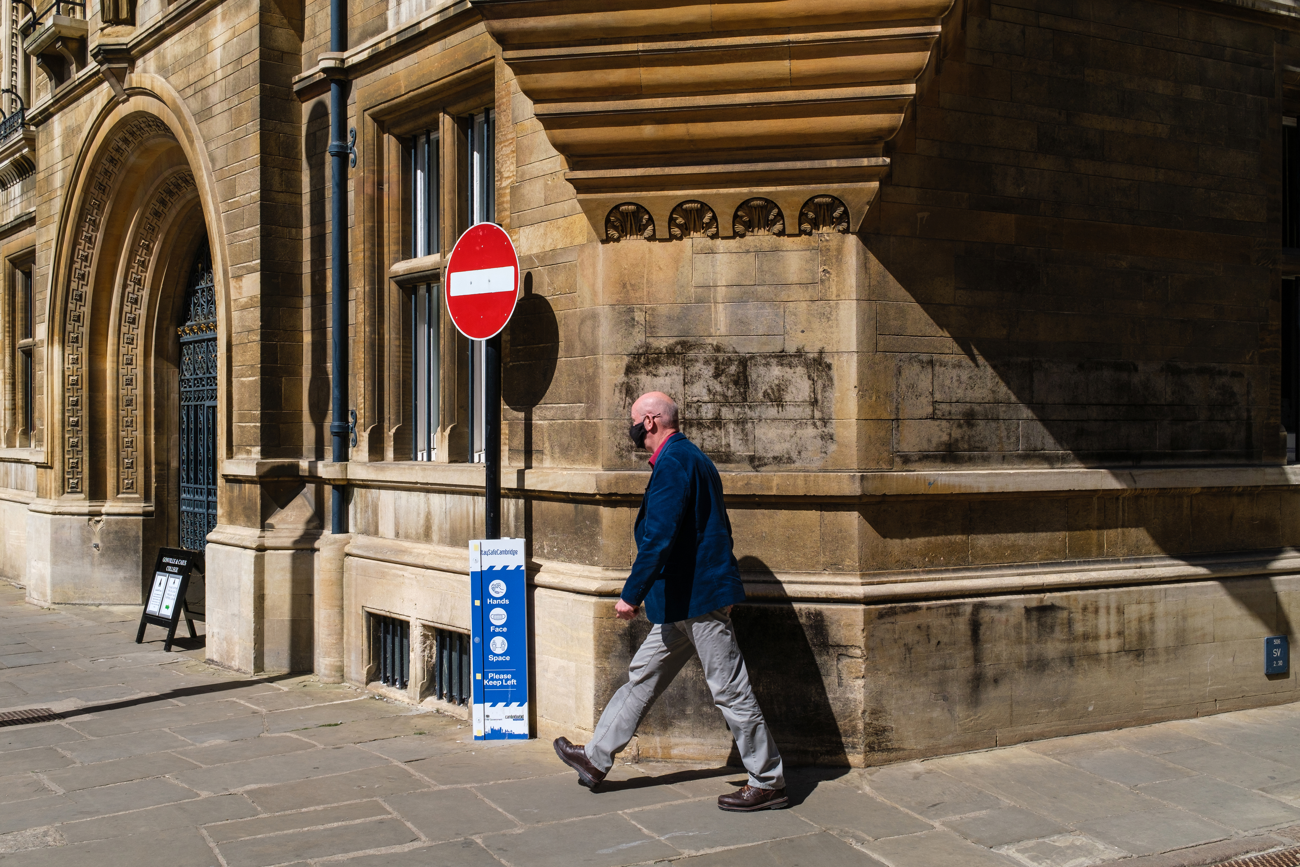 A man walking around a street corner