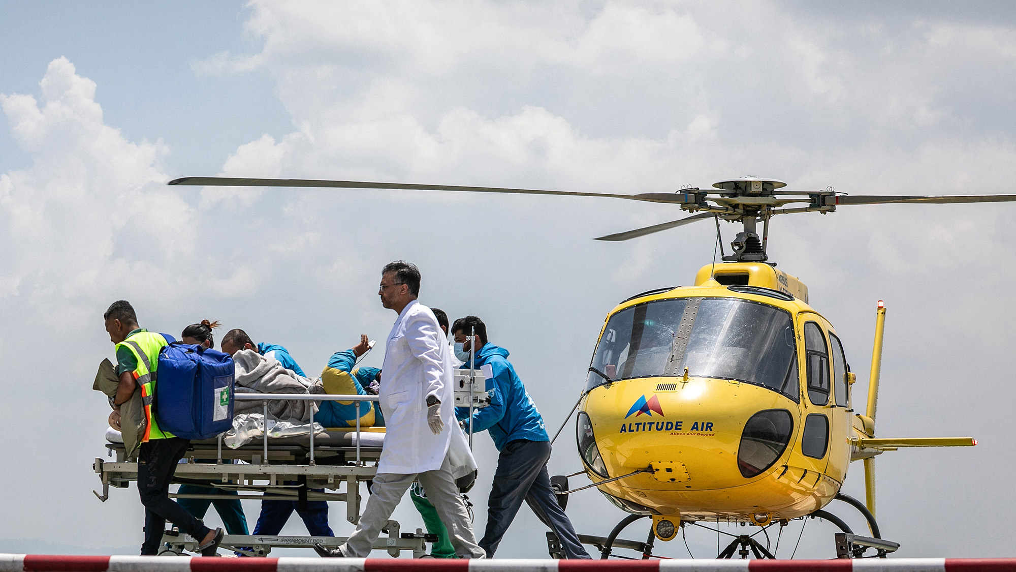 Rescuers transfer mountaineer Dawa Sherpa, who had been missing on Mt Everest for six days and was believed to have died, from a rescue helicopter to a hospital in Kathmandu