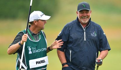 Clarke chats with a caddy whilst playing at Gleneagles