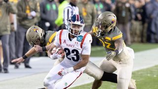  Devean Washington #23 of the Navy Midshipmen fights off the Army in the Army vs Navy live stream
