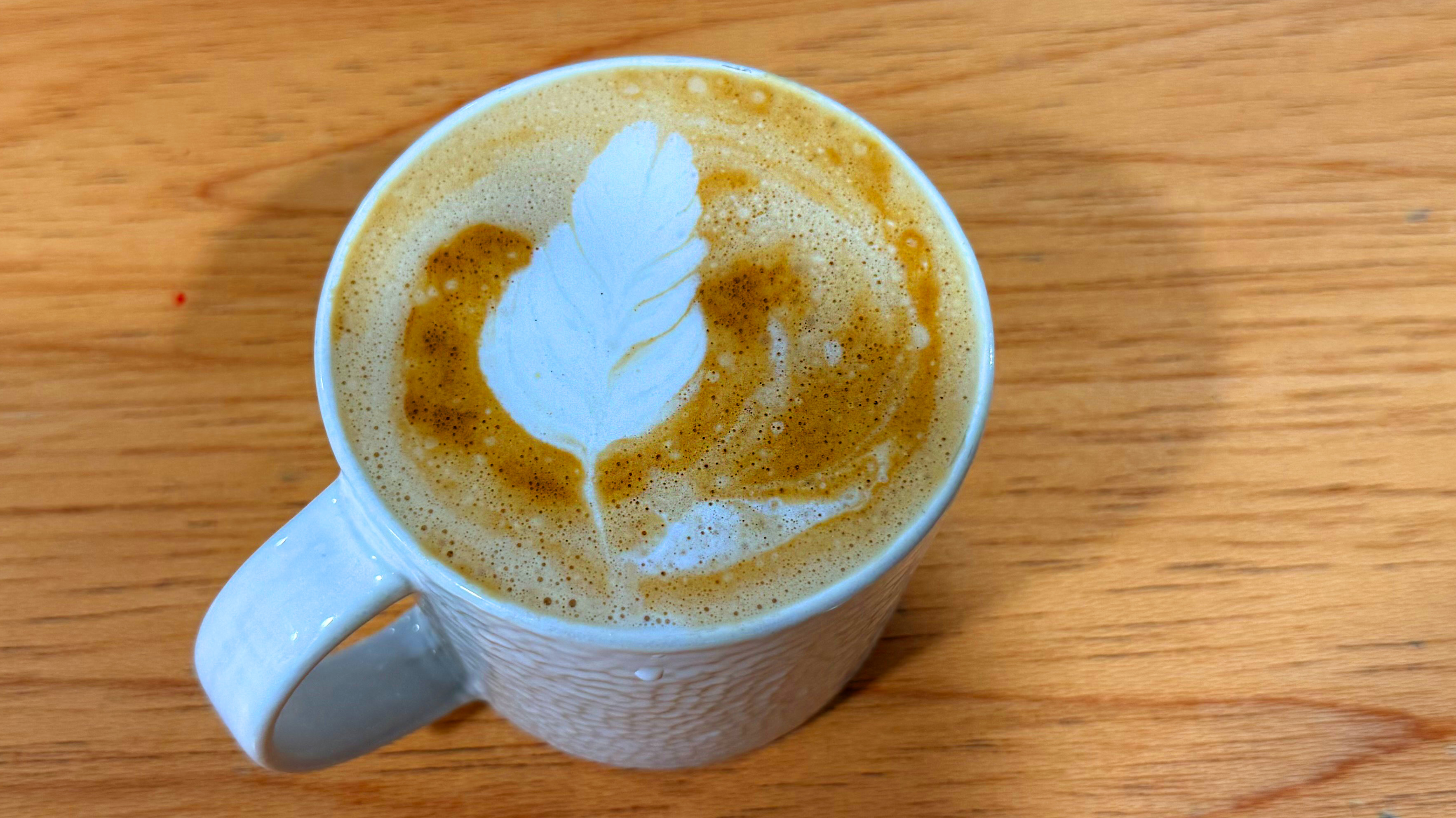 a photo of a latte made on the de'longhi linea classic