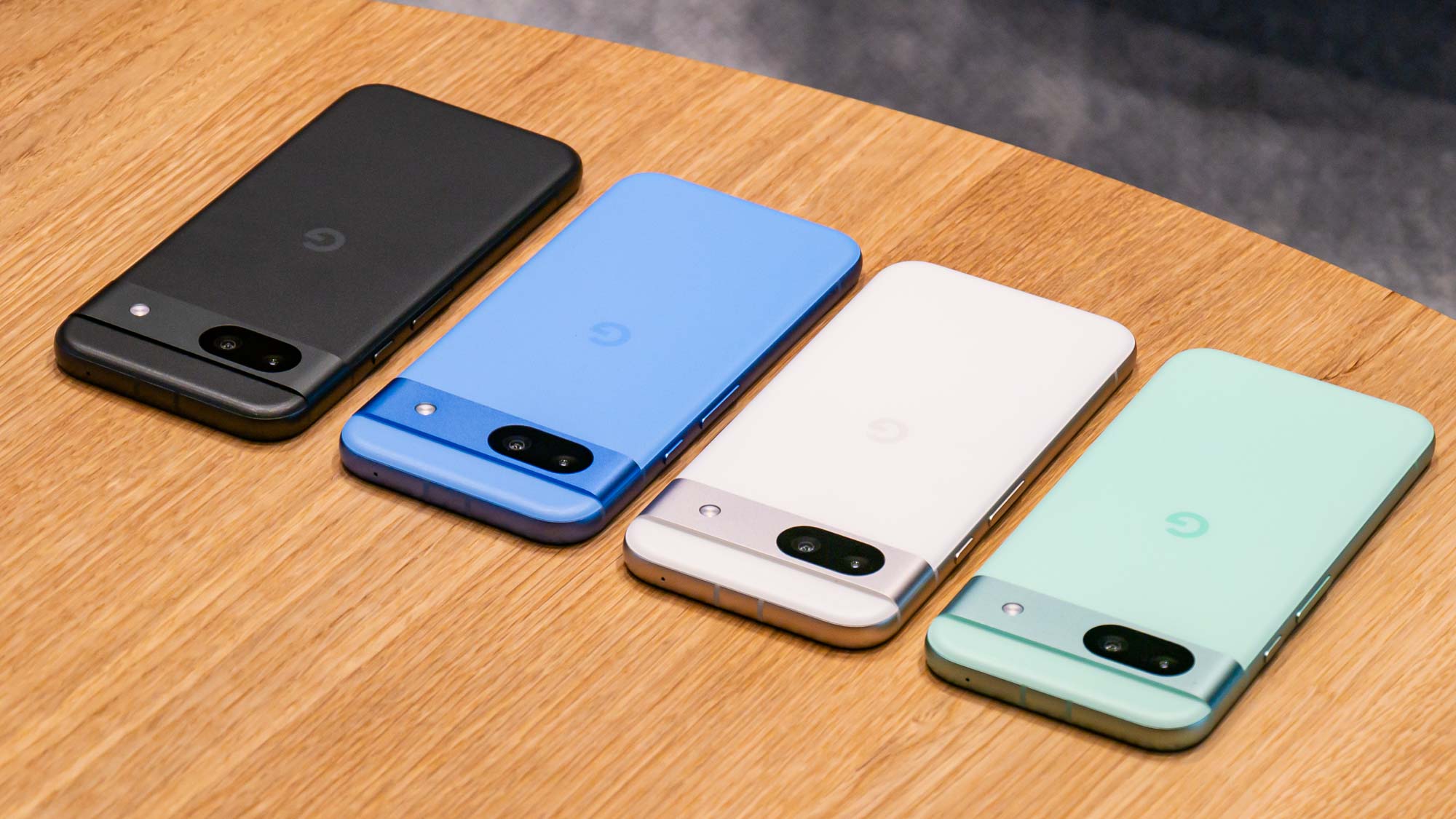 Google Pixel 8a in all four colors shown on table.