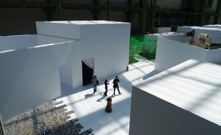 Guests walking between white boxed rooms