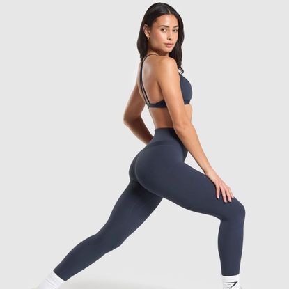model wearing blue gymshark bra and leggings