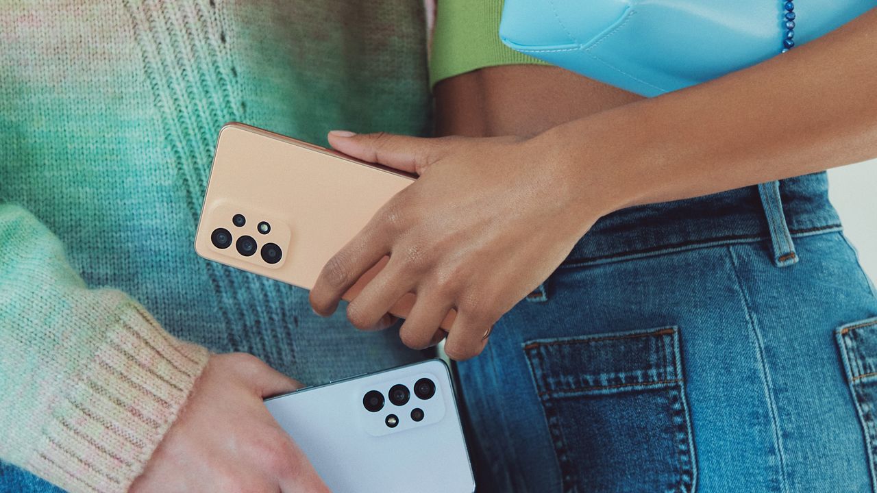 Samsung Galaxy phones being held by a man and a woman