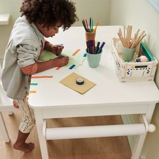 white desk with child playing 