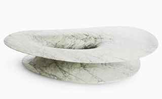 An egg shaped marble-like table.