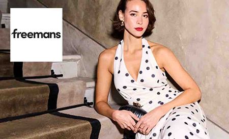 freemans logo top left with a model posing on stairs in a poka dot dress