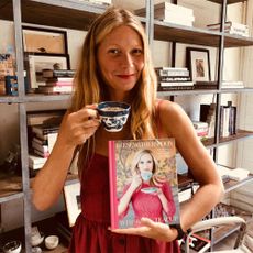 gwyneth paltrow holding tea cup and magazine