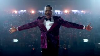 Colman Domingo stands with open arms in front of a hyped crowd in The Running Man.