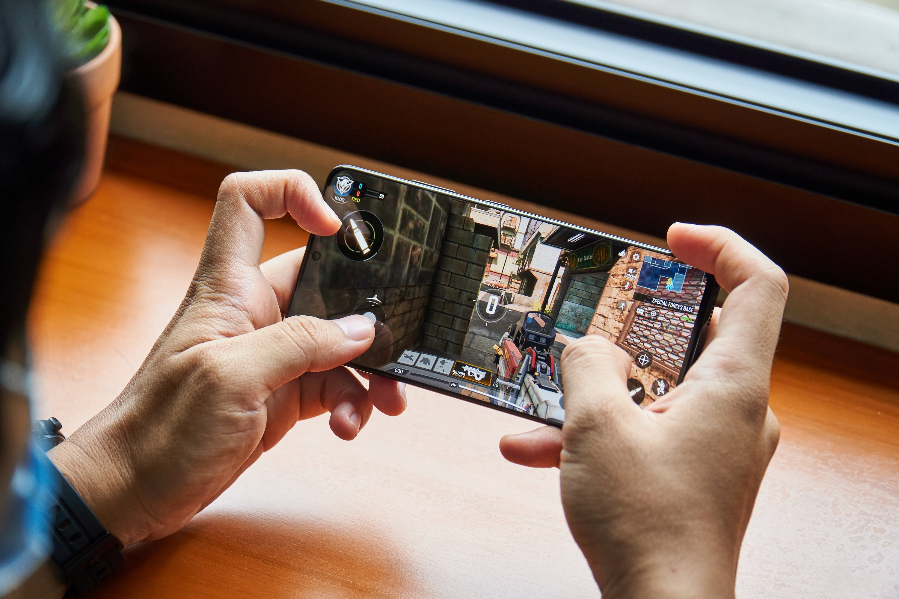 Playing free-to-play shooter video game Call of Duty: Mobile games on the Samsung Galaxy S21 Ultra flagship smartphone.