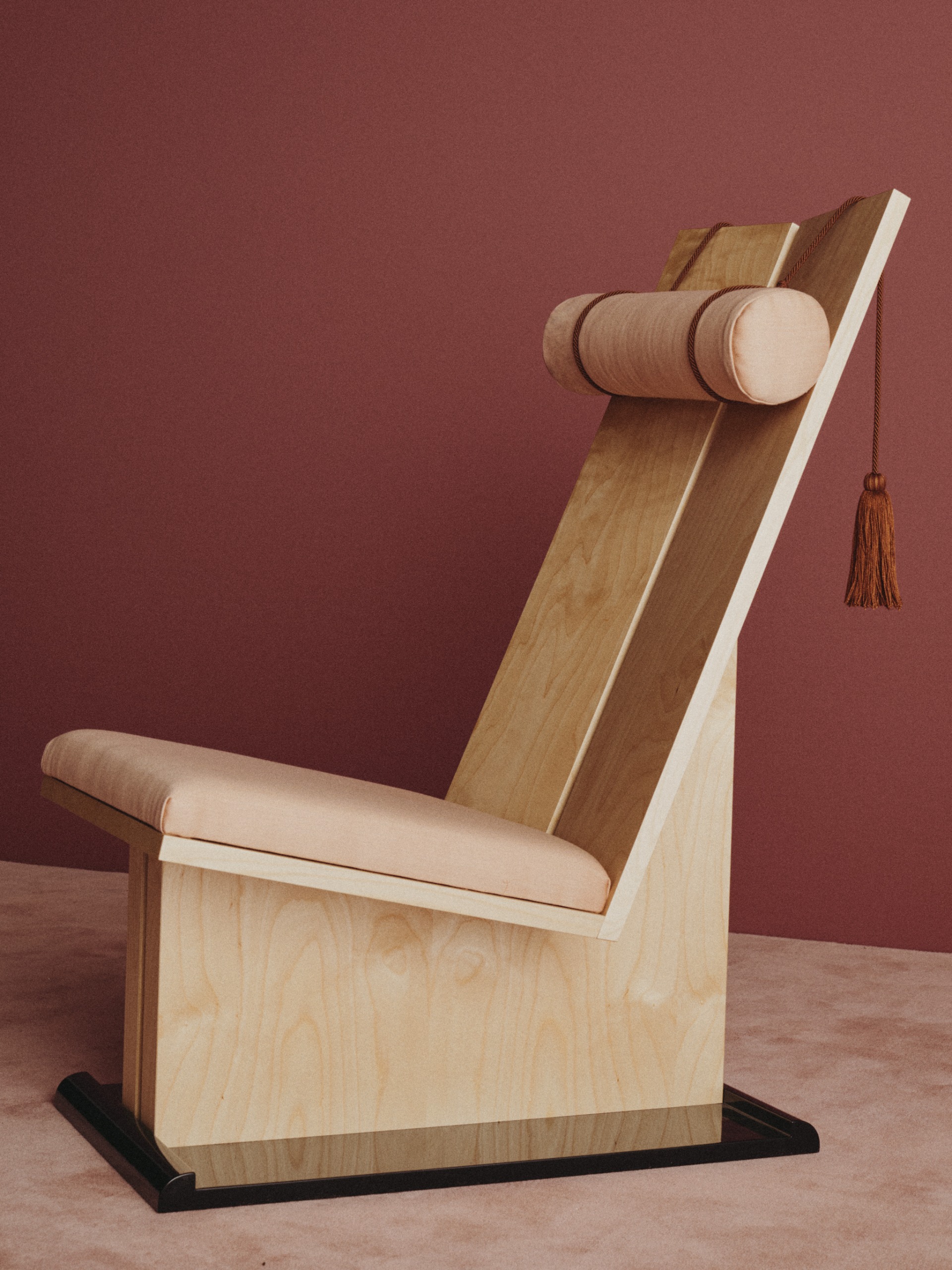 Birch and lacquer lounge chair with passementerie elements and a head bolster