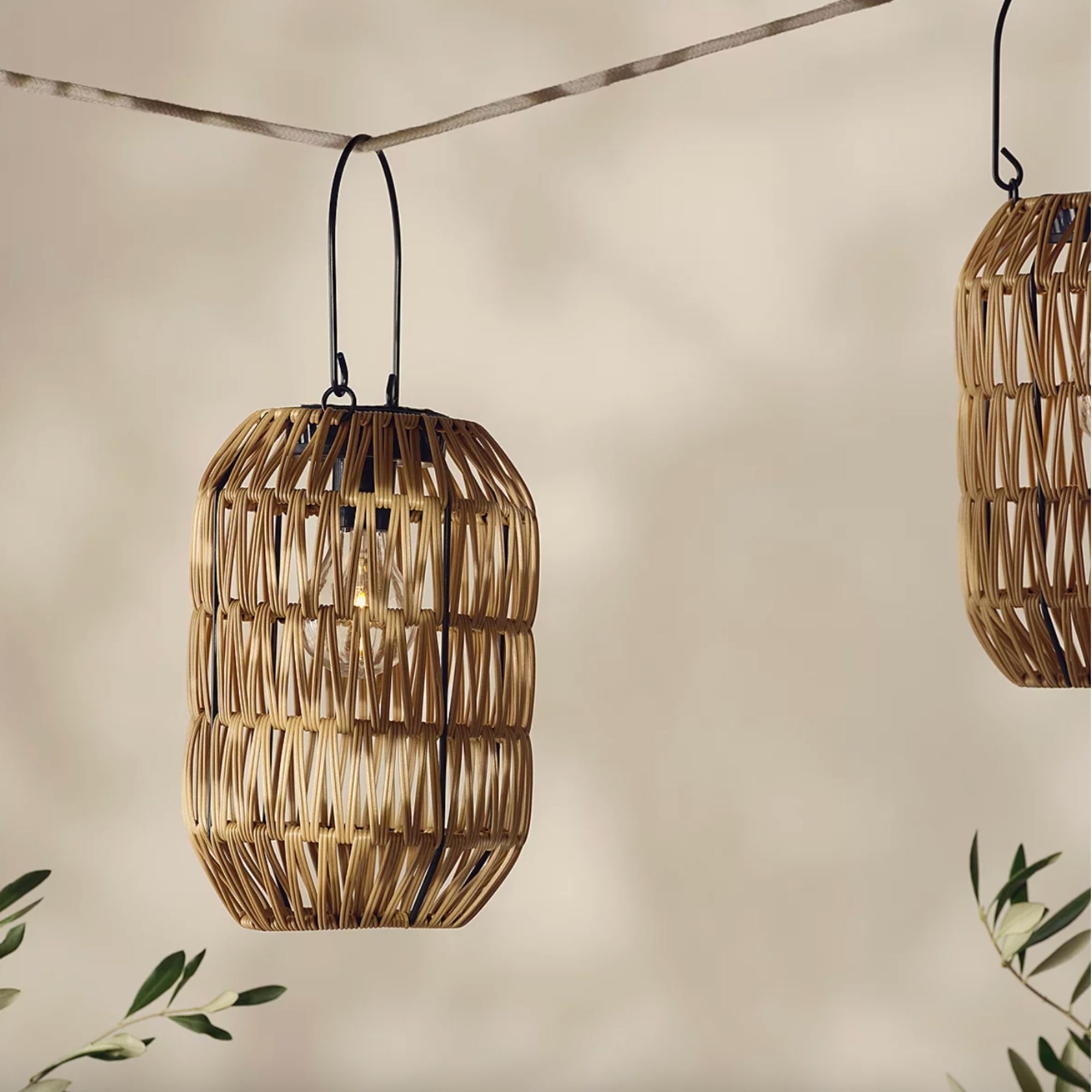 Wicker lantern hanging on string in garden