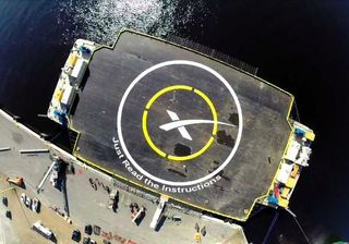 This photo, tweeted by SpaceX CEO Elon Musk on Jan. 29, 2015, shows personnel painting on the name of the company's first spaceport drone ship: "Just Read the Instructions." 