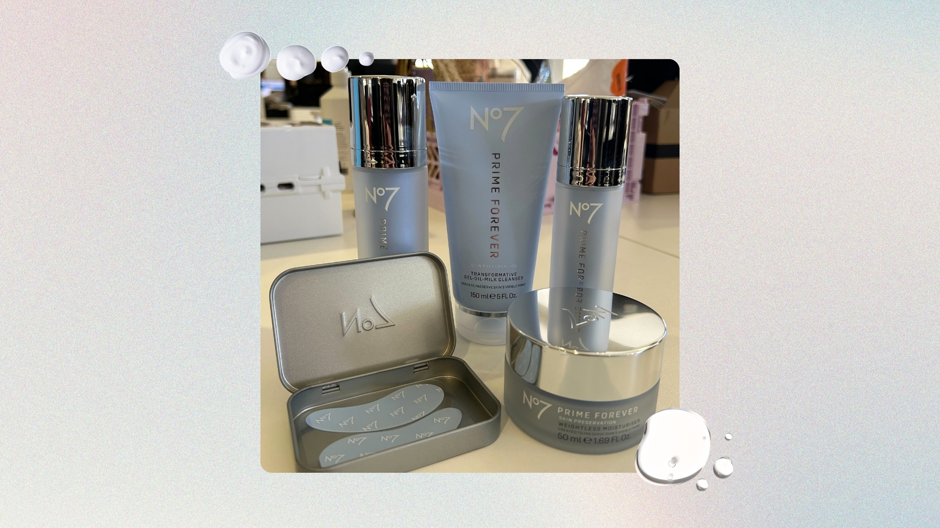 Image of the entire No7 Prime Forever skincare range, on a pastel watercolour background with white serum and cream swatches