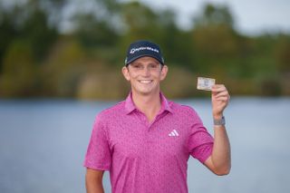 Jacob Bridgeman holds up his PGA Tour card