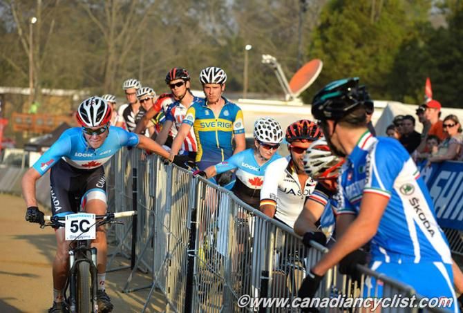 Canada's Mitch Bailey hands off to Sandra Walter for first place at the end of lap 3