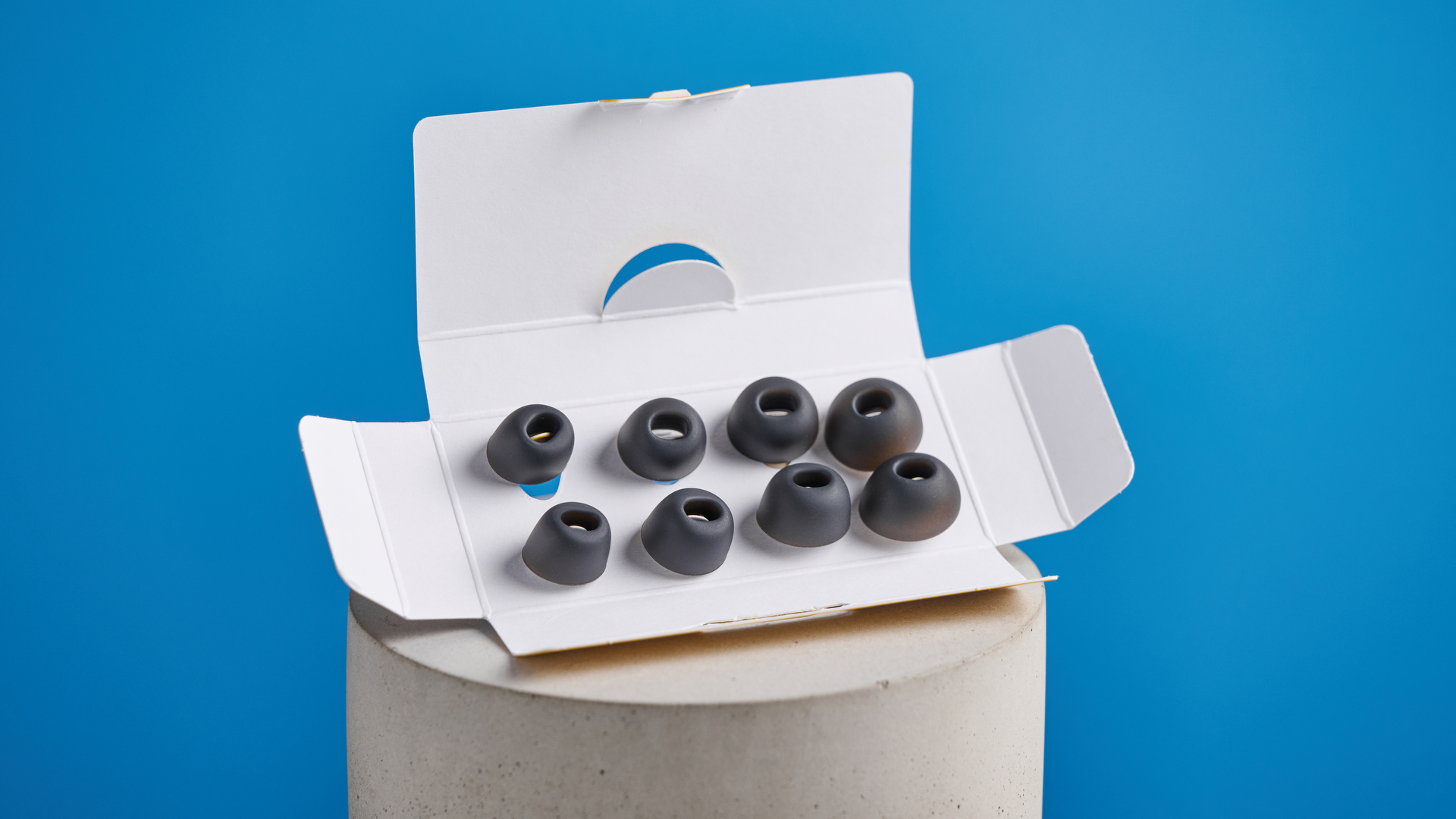 the earfun air pro 4+ earbuds in black showing the ear tips, charging case, and being worn