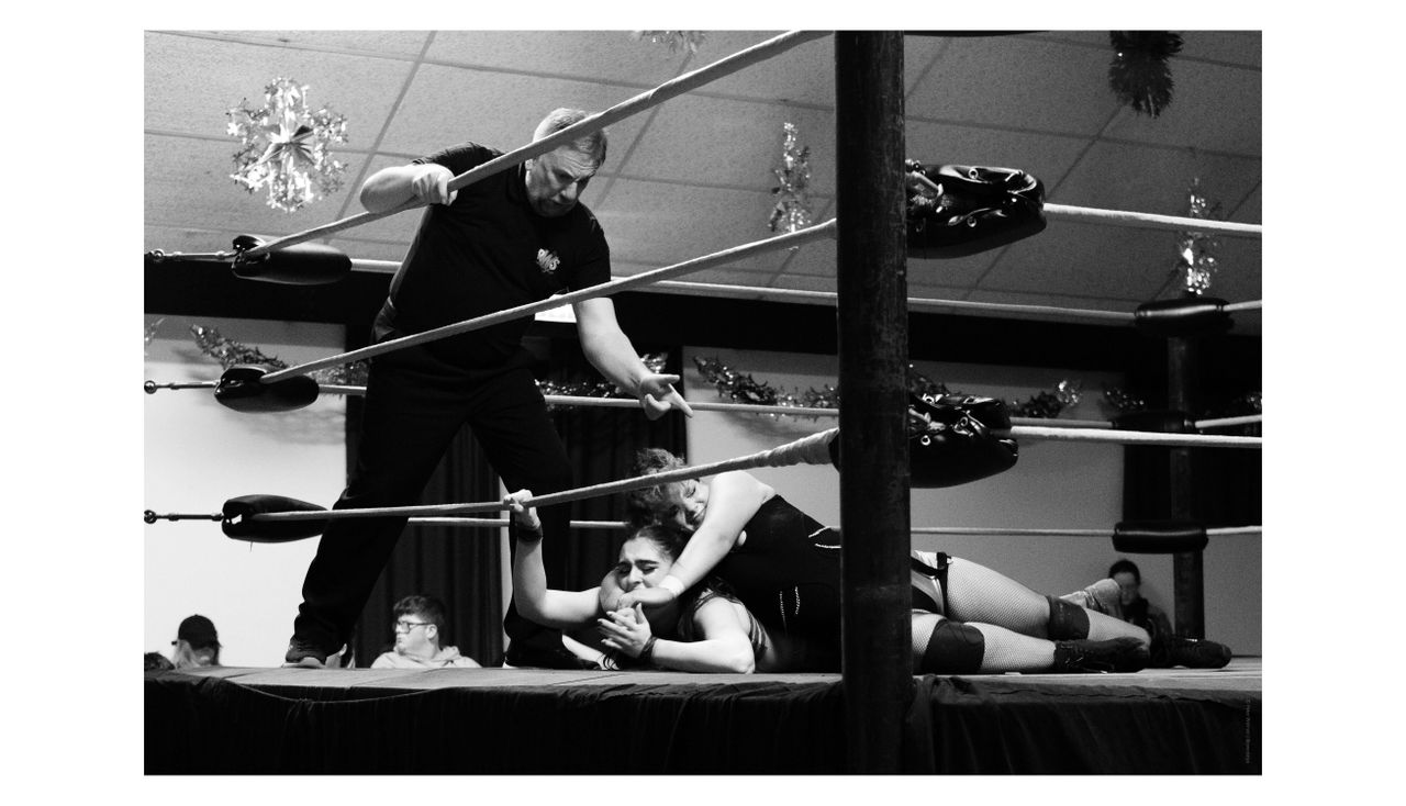 Black and white photo of a wrestling match