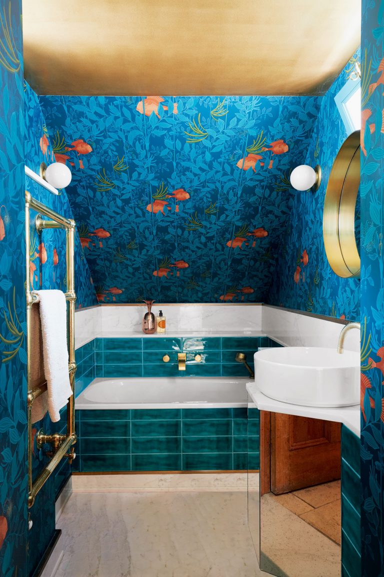 small bathroom with sea-inspired wallpaper and gold painted ceiling