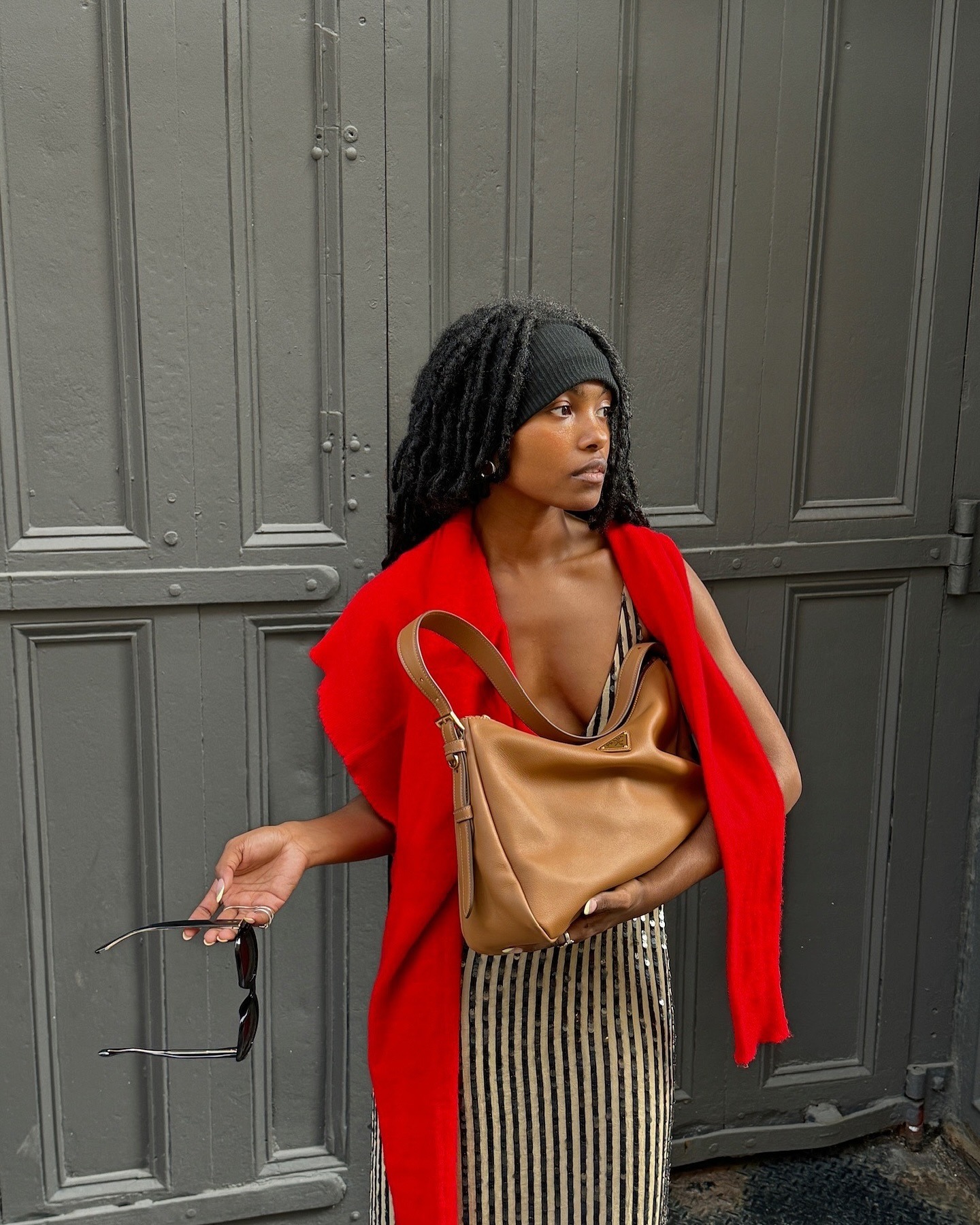 A woman with long locs wearing a headband.