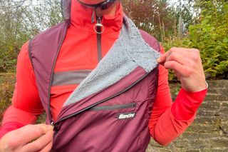 The Santini Alpha Pack Vest shown with zip pulled down revealing the fleecy inside