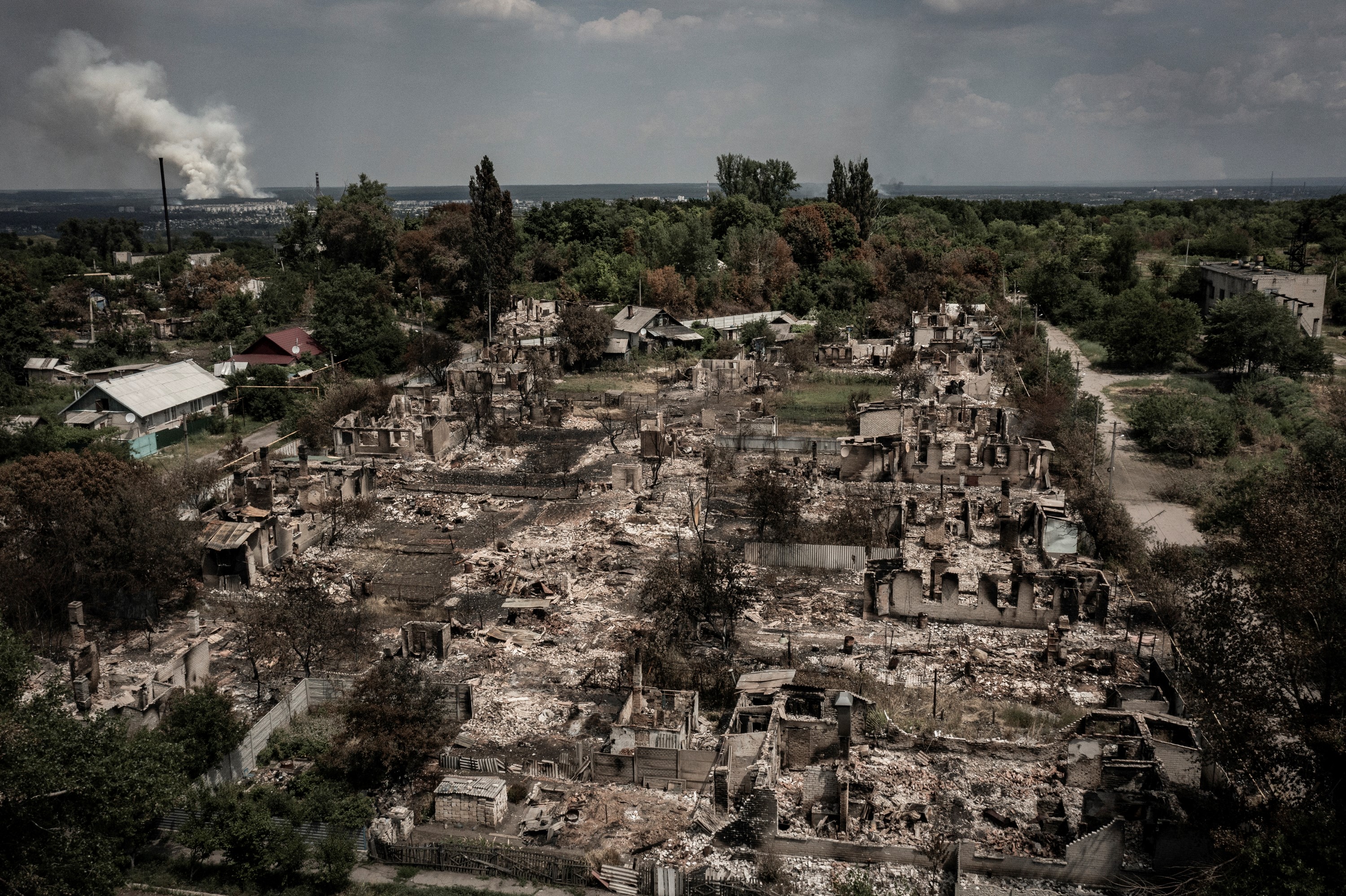 TOPSHOT - An aerial view shows destroyed houses after strike in the town of Pryvillya at the eastern Ukrainian region of Donbas on June 14, 2022, amid Russian invasion of Ukraine. - The cities of Severodonetsk and Lysychansk, which are separated by a river, have been targeted for weeks as the last areas still under Ukrainian control in the eastern Lugansk region. (Photo by ARIS MESSINIS / AFP) (Photo by ARIS MESSINIS/AFP via Getty Images)