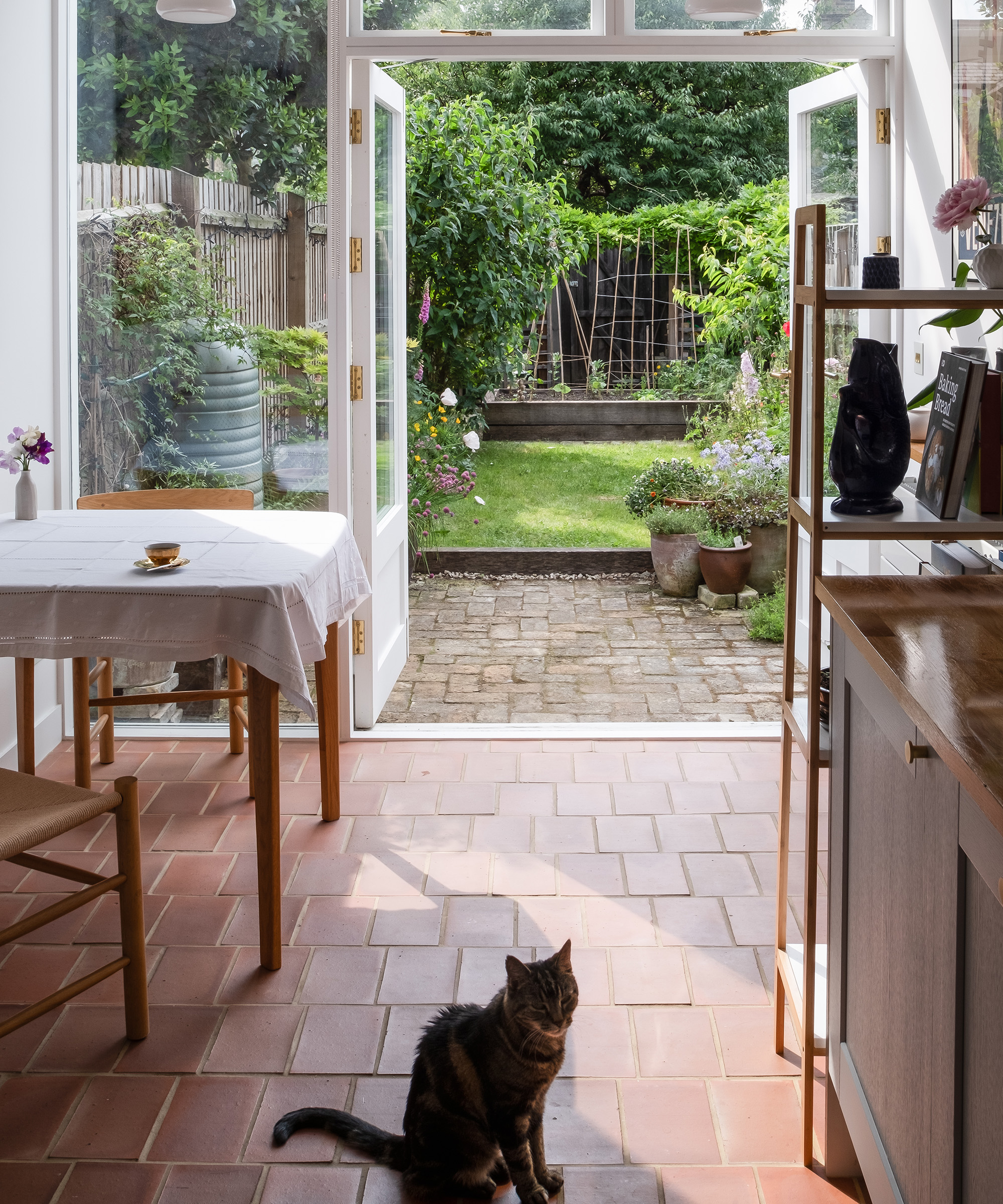 A view out into a garden from a small kitchen extension with french doors