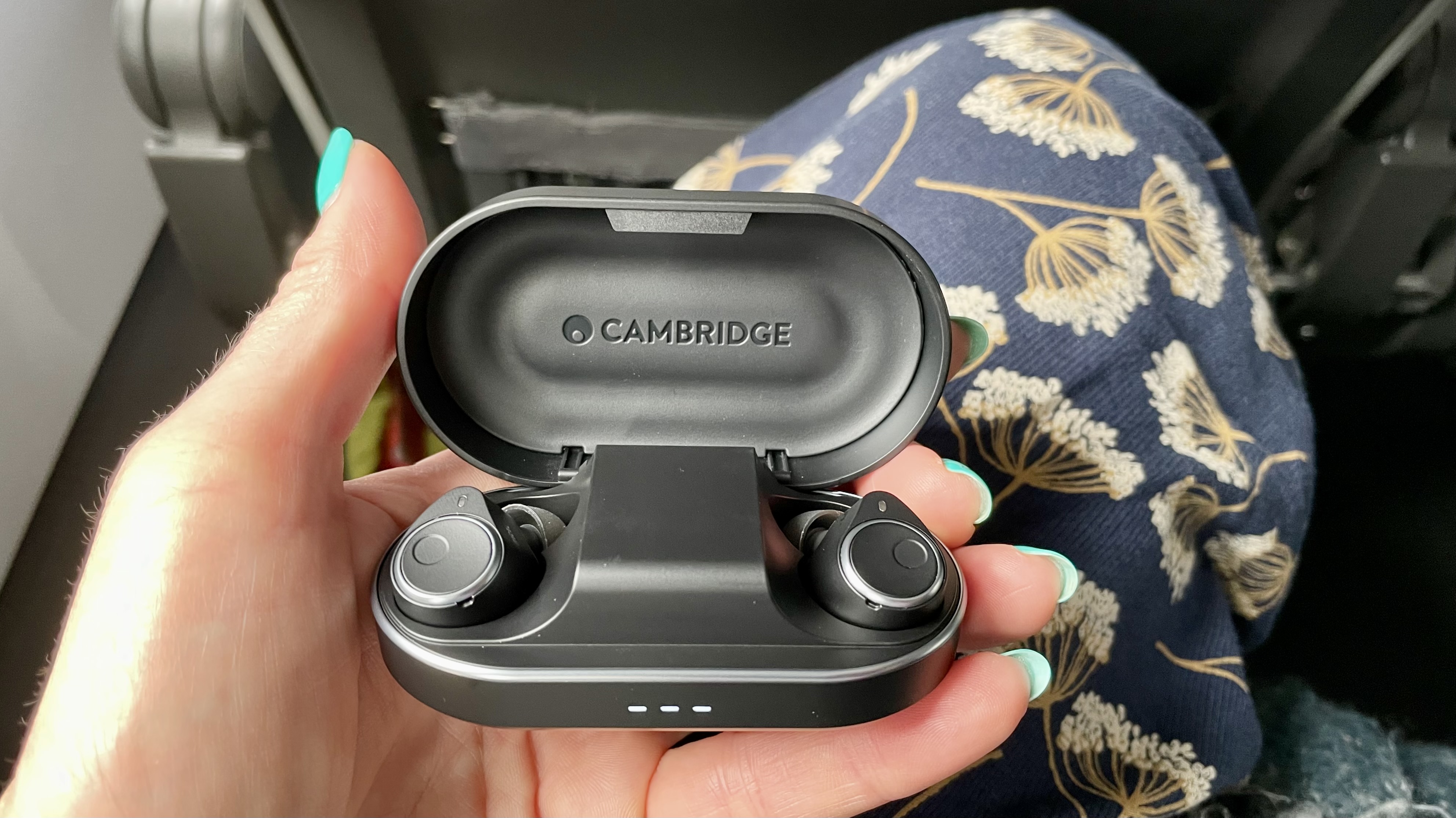 Cambridge Audio M100 in their case, held in a hand