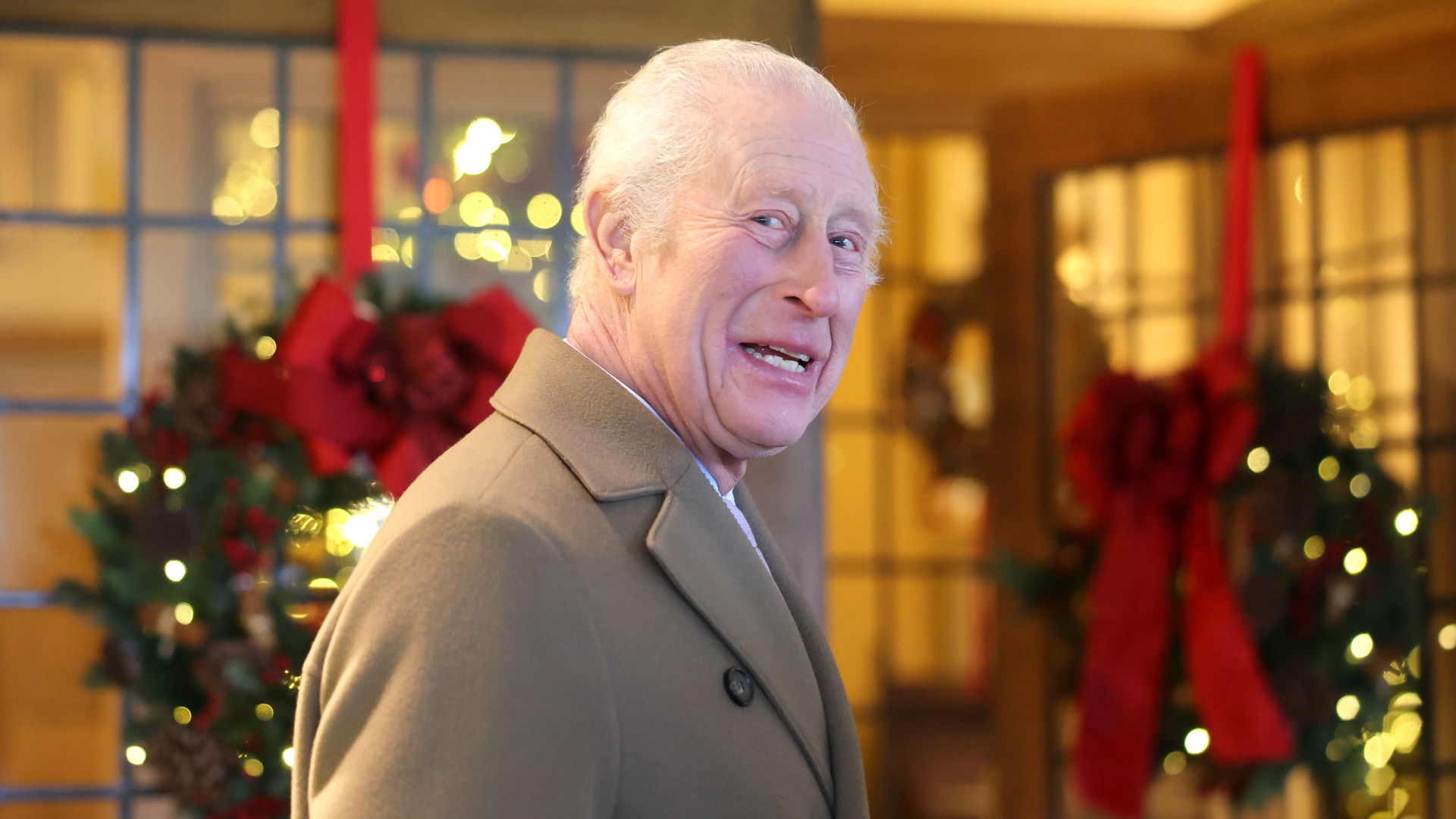 King Charles wearing a tan coat at Christmas time