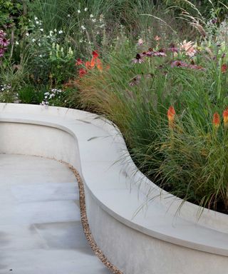 Chelsea show garden 2021 with paving and built-in curved bench