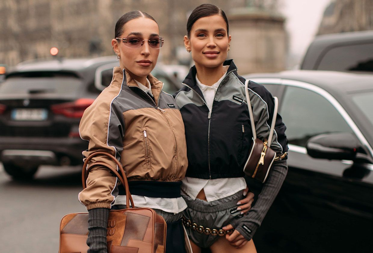 Two women in Miu Miu track jackets.