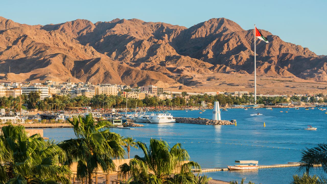 Scenic view of sea and mountains against clear blue sky,Aqaba,Jordan