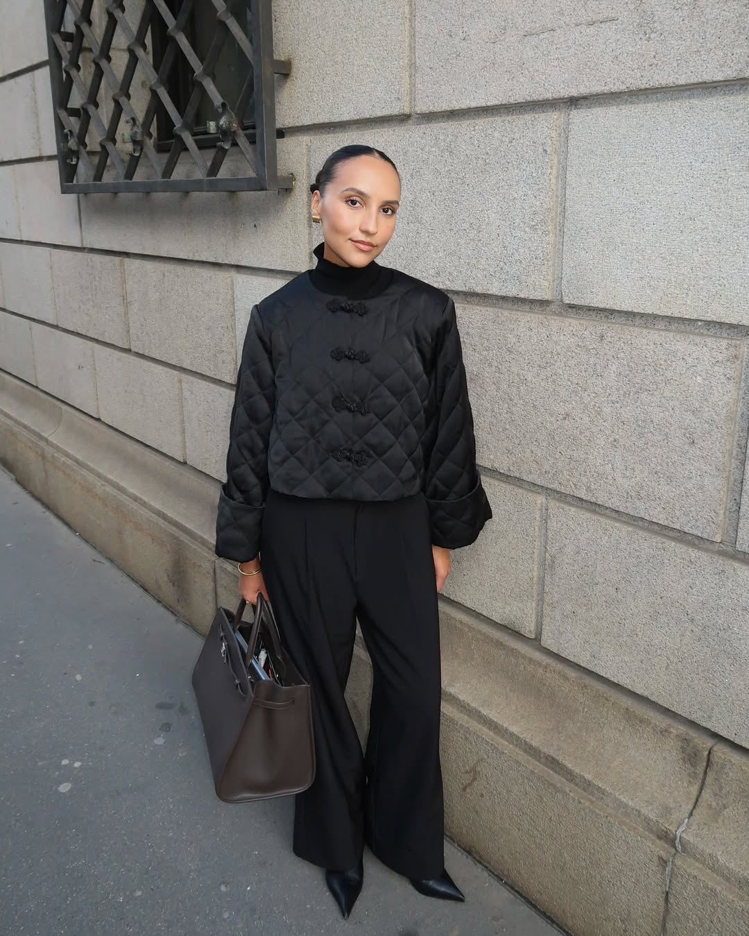 Influencer Ingrid Fagerli Edvinsen wearing a cropped quilted jacket, tailored trousers and pointed black boots.