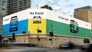 Volkswagen OOH billboard showing a new VW bus with the text it's back, its front, its back again