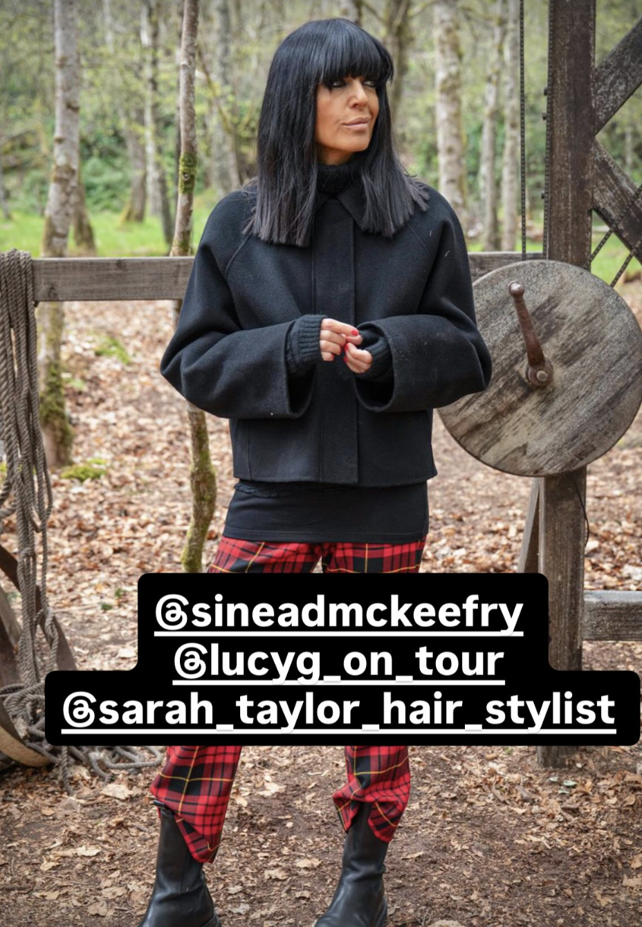 Claudia Winkleman wearing black jacket and tartan trousers.