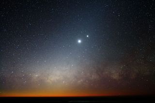 The Moon and Venus shine in the skies of Cerro Paranal, home of ESO’s Very Large Telescope (VLT). Below them, the Milky Way glows crimson.