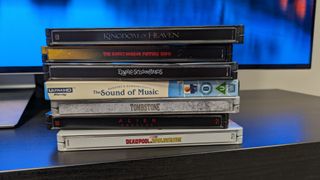 4K Blu-ray collection listing image with kingdom of heaven, sound of music, tombstone, Deadpool and Wolverine, alien: romulus and rocky horror 4K Blu-ray cases in a pile