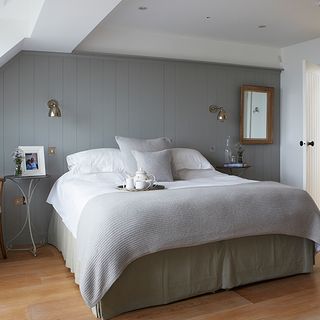bedroom with grey wall bedside metallic wall and lamps