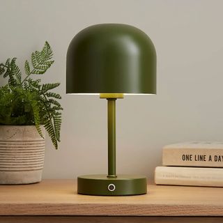 Dunelm wireless rechargeable lamp in Green on a sideboard beside some books