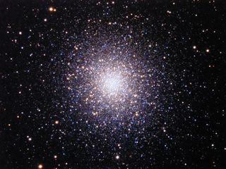 The great Globular Cluster of Hercules, also known as Messier 13 (or M13), is a large and bright spherical cluster of old stars that is readily seen with unaided eyes away from city lights. A telescope reveals the salt-spilled-on-velvet appearance.