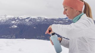 winter trail running gear: runner with flask