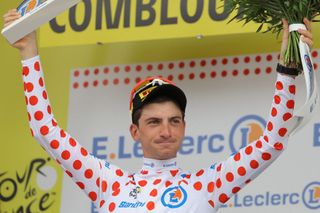 Lidl - Trek's Italian rider Giulio Ciccone celebrates on the podium with the the best climber's polka dot (dotted) jersey after the 16th stage of the 110th edition of the Tour de France cycling race, 22 km individual time trial between Passy and Combloux, in the French Alps, on July 18, 2023. (Photo by Thomas SAMSON / AFP)