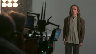 Ben Kingsley as Trevor Slattery posing in front of a film camera