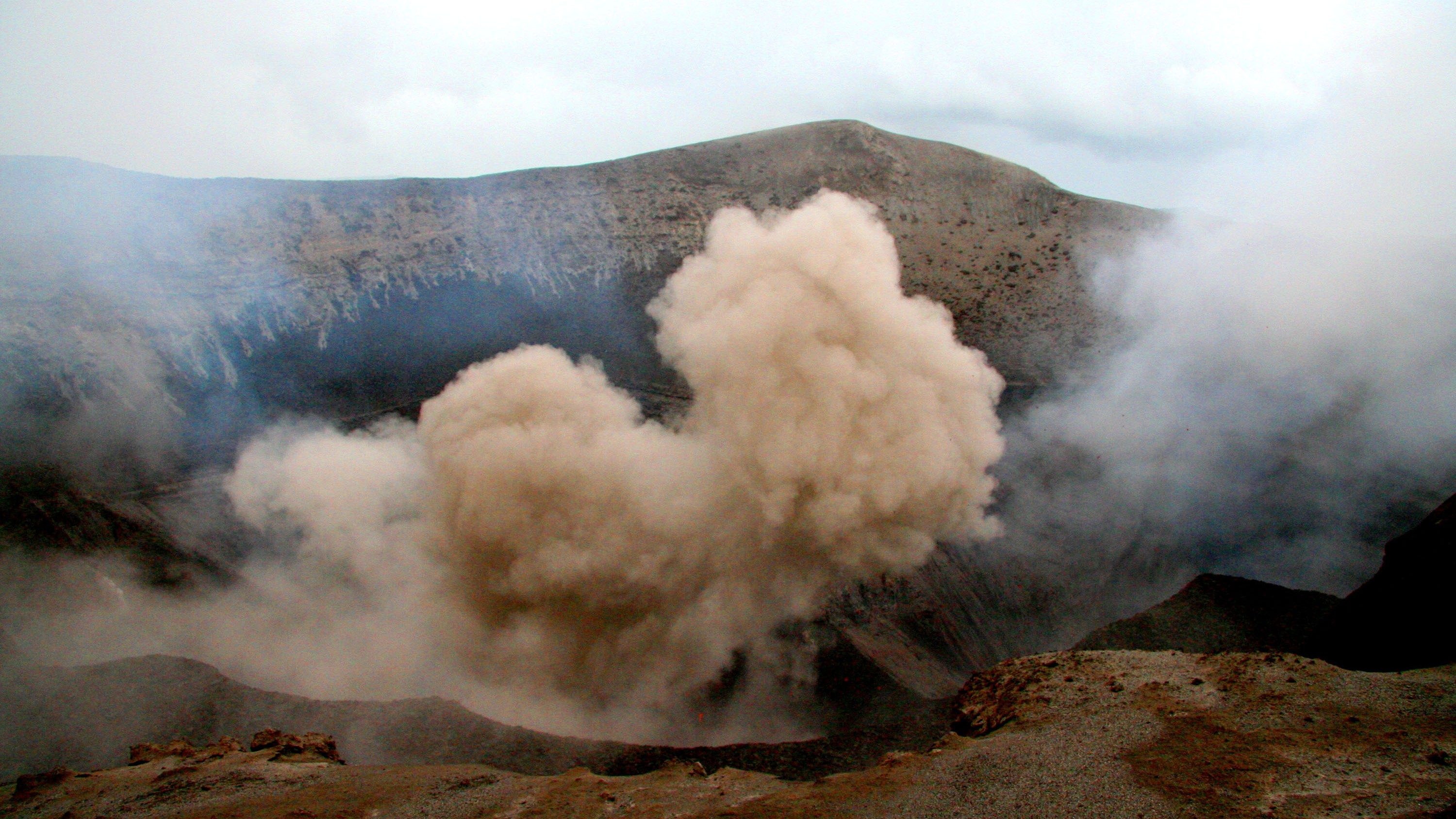 smoke coming from a volcano vent