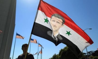 A supporter of Syrian President Bashar al-Assad waves a flag at a Sept. 7 rally in Los Angeles.